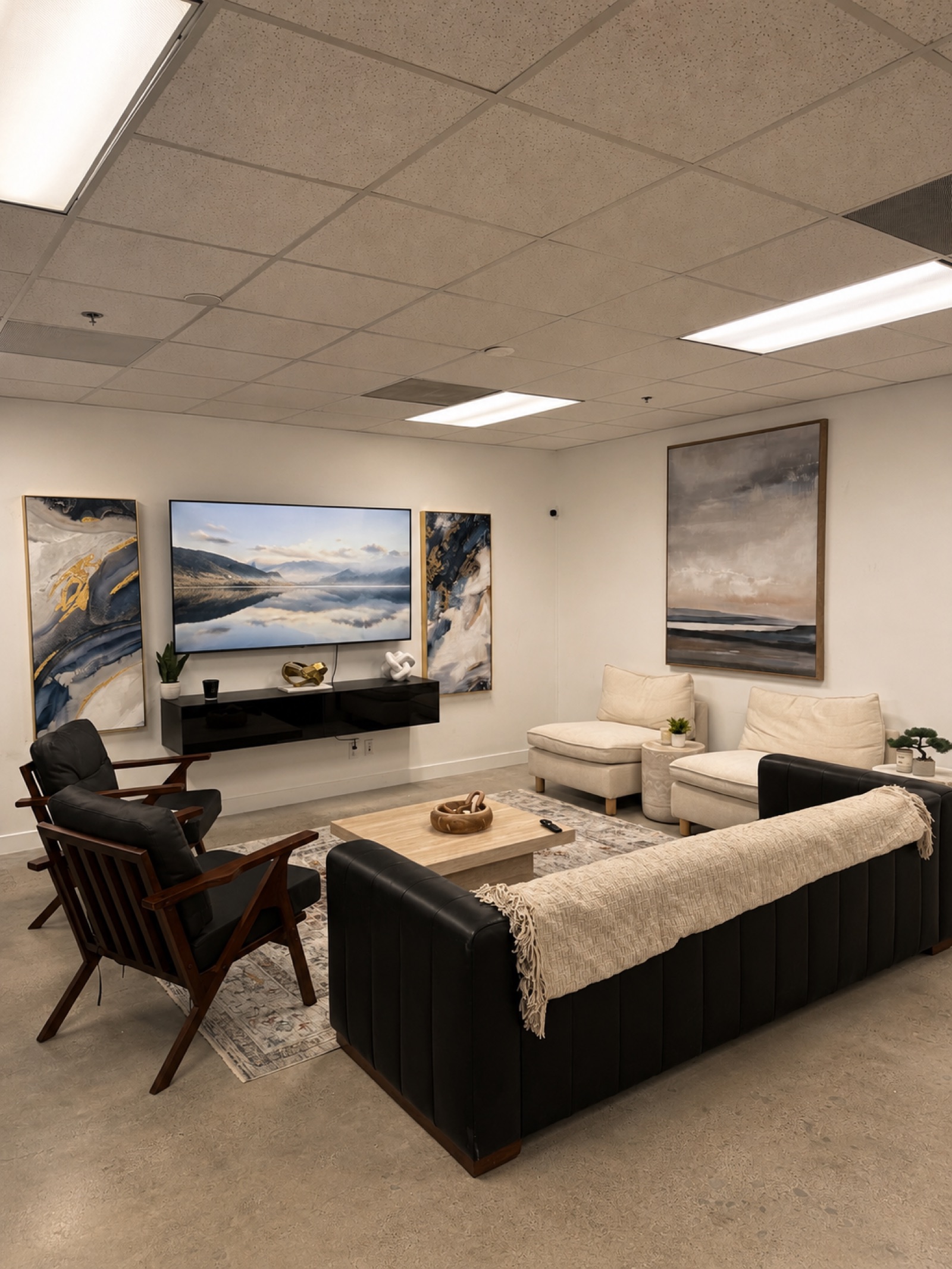 Lounge and common area with media wall, sofas and lounge chairs
